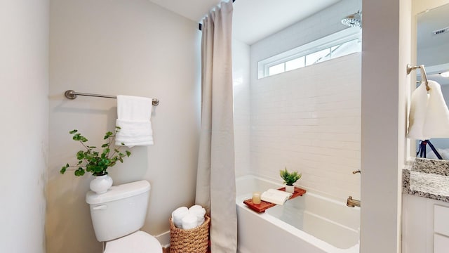 bathroom featuring toilet, shower / tub combo, and vanity
