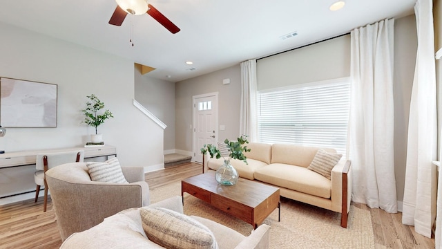 living area featuring light wood-style flooring, ceiling fan, recessed lighting, and baseboards