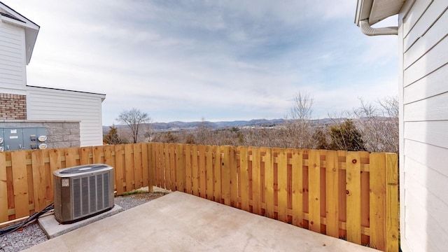 view of patio / terrace featuring cooling unit and fence