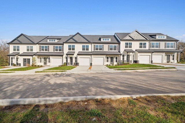 townhome / multi-family property featuring an attached garage and driveway