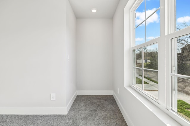 empty room with carpet, baseboards, and plenty of natural light