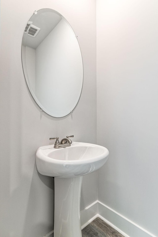 bathroom featuring baseboards and a sink