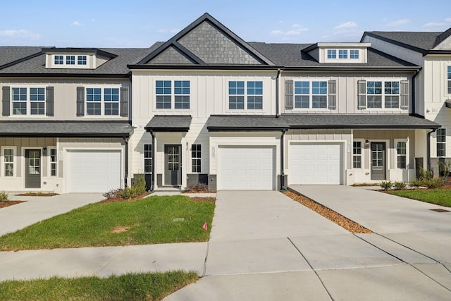 townhome / multi-family property featuring an attached garage, driveway, and board and batten siding