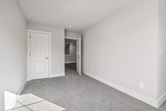 unfurnished bedroom with baseboards and carpet floors
