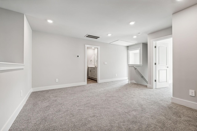 unfurnished room featuring baseboards, visible vents, carpet floors, and recessed lighting