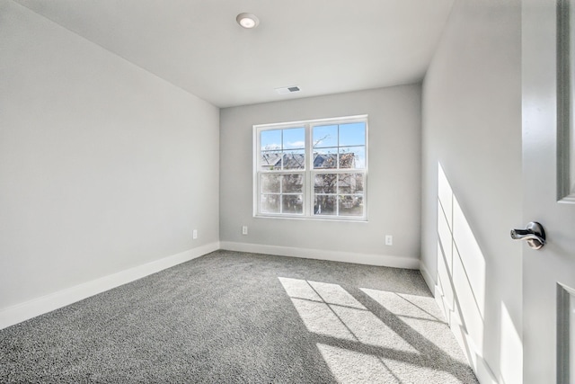 spare room featuring visible vents, carpet flooring, and baseboards