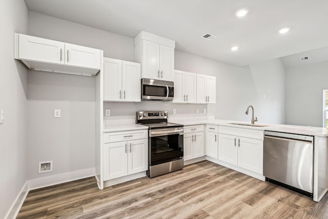 kitchen featuring white cabinets, a sink, visible vents, recessed lighting, and appliances with stainless steel finishes