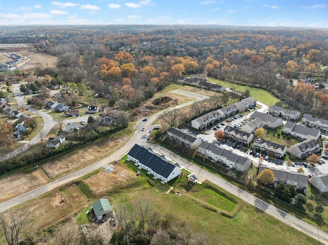 birds eye view of property featuring a forest view