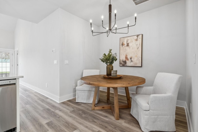 dining area with light wood-style floors, visible vents, baseboards, and an inviting chandelier