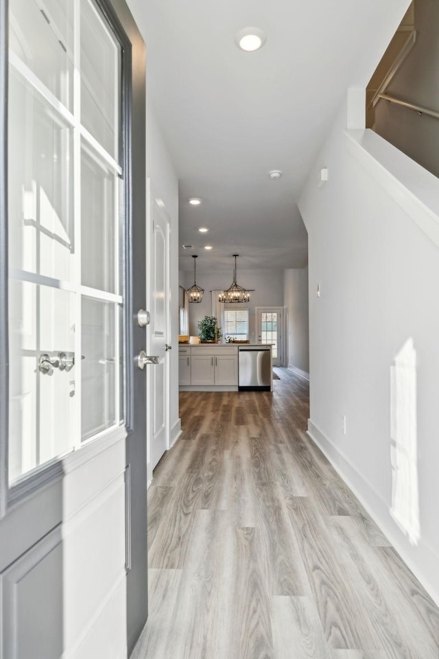 entrance foyer featuring baseboards, recessed lighting, and light wood-type flooring