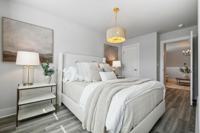 bedroom featuring wood finished floors and baseboards