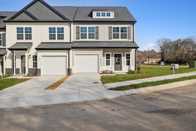 townhome / multi-family property featuring board and batten siding, driveway, a garage, and roof with shingles