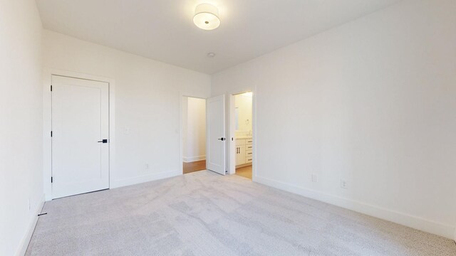 108 Shadow Springs Dr Unit 108, Brentwood, TN 37027 - unfurnished bedroom with baseboards, light colored carpet, and connected bathroom