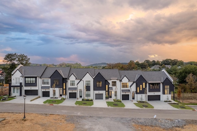 108 Shadow Springs Dr Unit 108, Brentwood, TN 37027 - view of front of house with a residential view, a standing seam roof, driveway, an attached garage, and board and batten siding