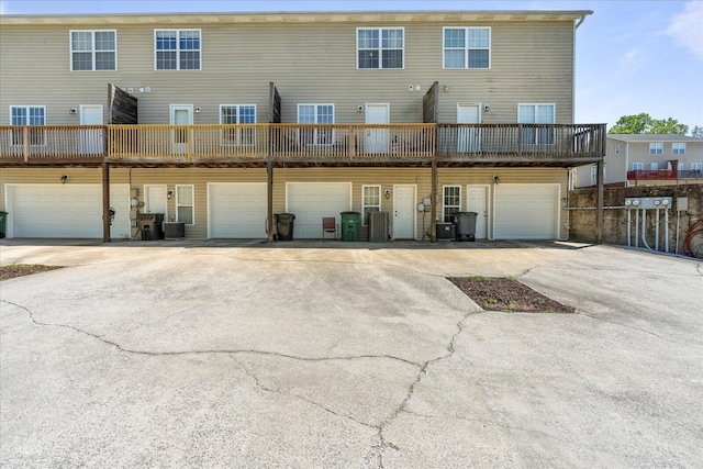 9051 Haileys Pond Dr, Ooltewah, TN 37363 - rear view of property with an attached garage, driveway, and cooling unit