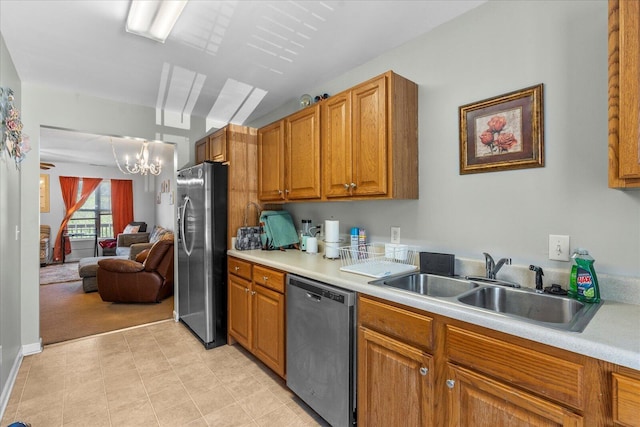 9051 Haileys Pond Dr, Ooltewah, TN 37363 - kitchen with stainless steel appliances, light countertops, a sink, and a notable chandelier