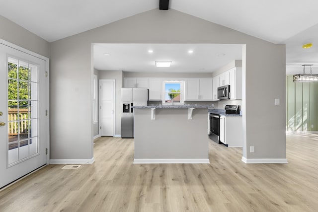 302 Windrush Dr, Clarksville, TN 37042 - kitchen featuring light wood-style floors, appliances with stainless steel finishes, a kitchen breakfast bar, and white cabinetry