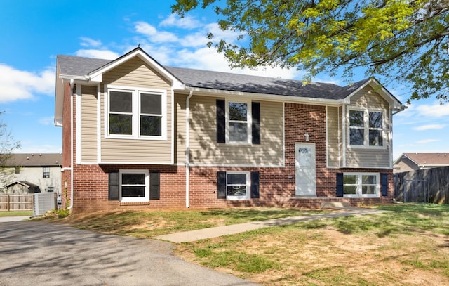 302 Windrush Dr, Clarksville, TN 37042 - split foyer home with brick siding, a front yard, and fence