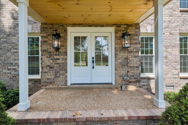 doorway to property featuring brick siding