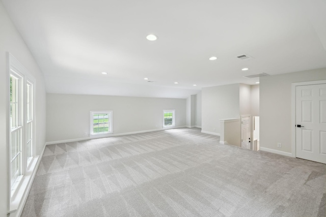 empty room featuring recessed lighting, baseboards, and light carpet