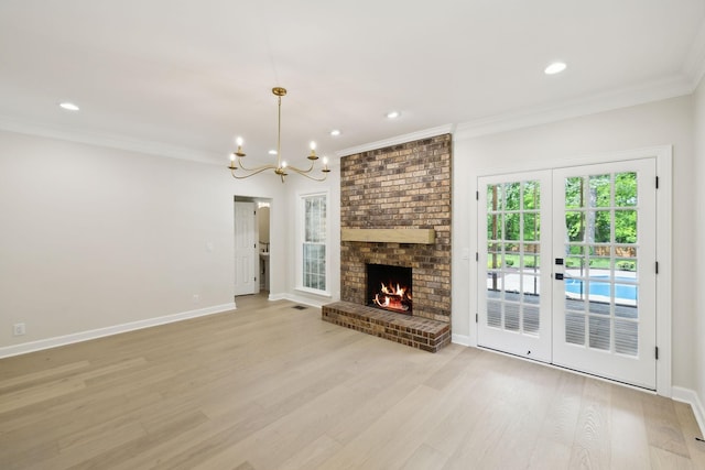 unfurnished living room featuring ornamental molding, baseboards, recessed lighting, light wood-style flooring, and a notable chandelier
