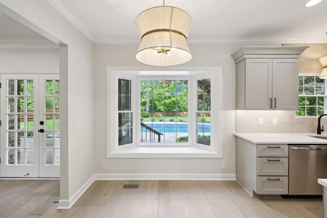 interior space with visible vents, light countertops, light wood finished floors, dishwasher, and gray cabinetry