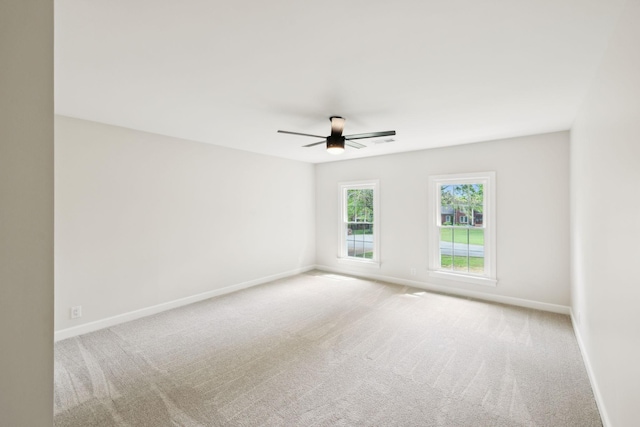 unfurnished room featuring baseboards, ceiling fan, and carpet floors