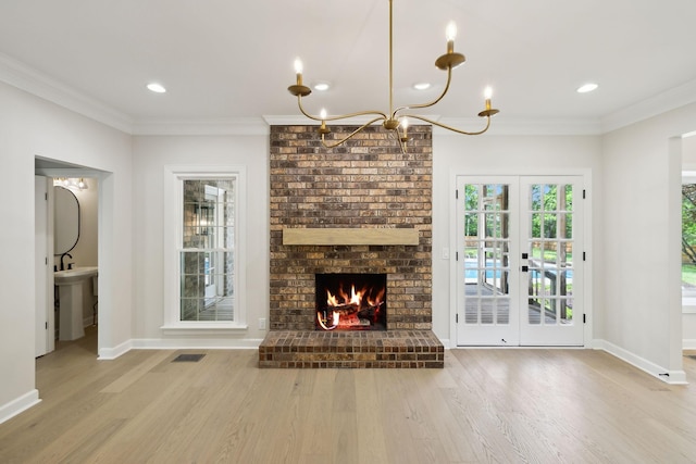 unfurnished living room featuring baseboards, crown molding, wood finished floors, and visible vents