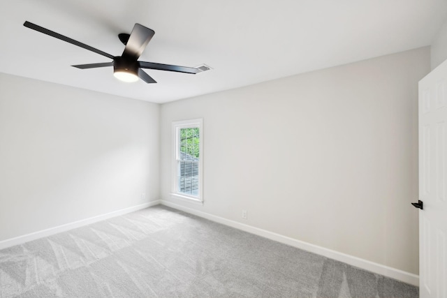 unfurnished room featuring baseboards, ceiling fan, visible vents, and light carpet