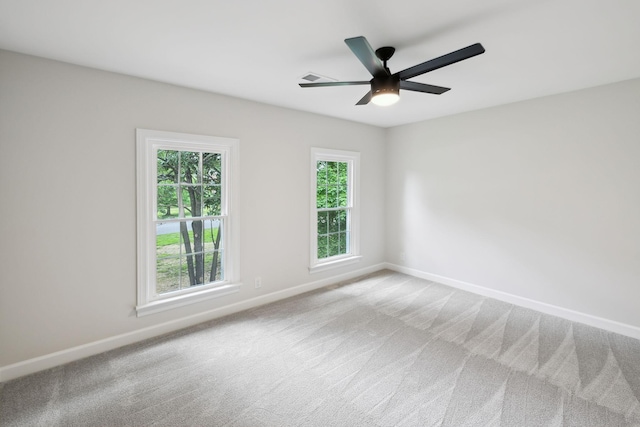 unfurnished room with baseboards, ceiling fan, and carpet flooring