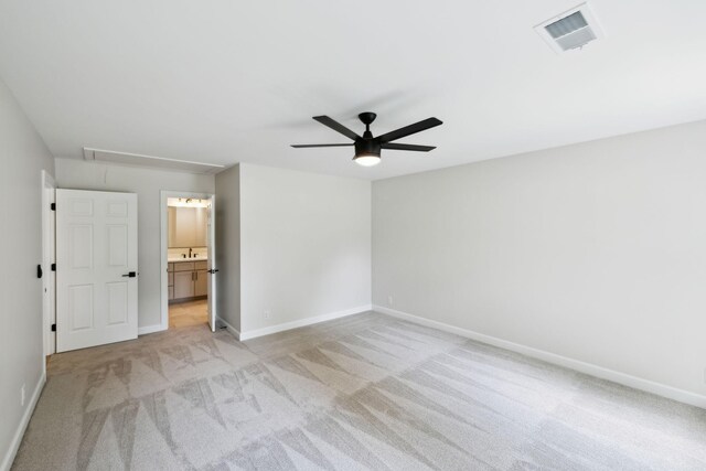 unfurnished bedroom with baseboards, visible vents, light carpet, and attic access