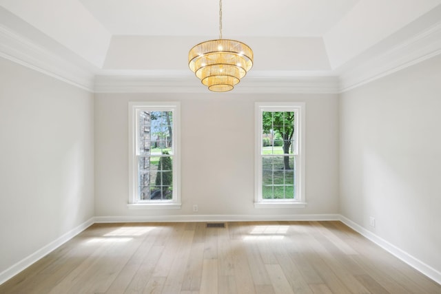 spare room with baseboards, hardwood / wood-style flooring, and a notable chandelier