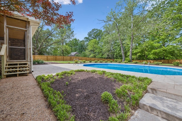 view of swimming pool featuring a fenced in pool, a fenced backyard, and a patio area