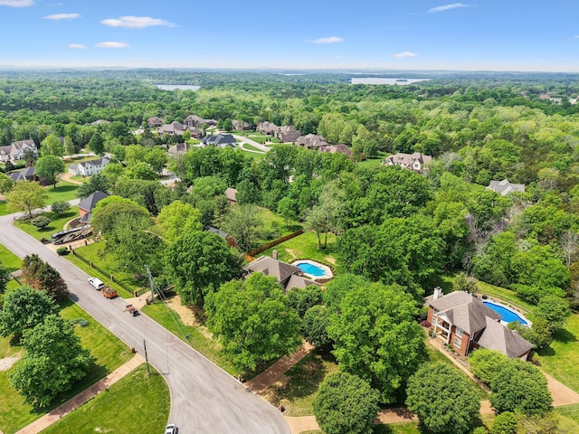 drone / aerial view with a wooded view