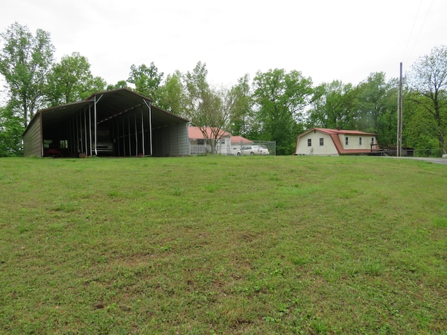 view of yard featuring a carport and a pole building