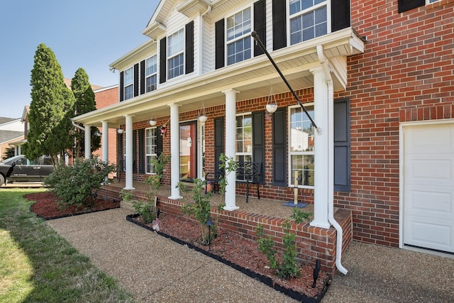 view of front facade featuring brick siding and covered porch