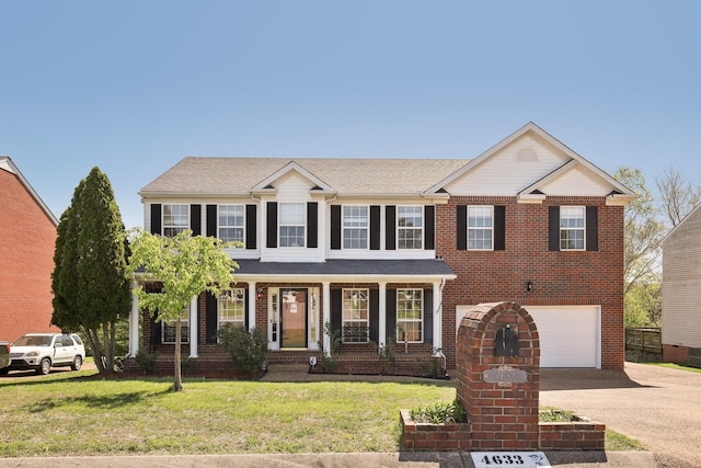 view of front facade featuring a front lawn, driveway, a garage, brick siding, and a shingled roof