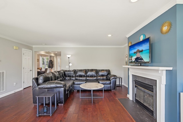 living room with a fireplace with flush hearth, ornamental molding, and wood finished floors