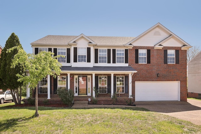 view of front of property featuring a front lawn, covered porch, concrete driveway, brick siding, and an attached garage