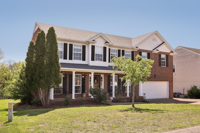 view of front of property with covered porch, brick siding, a front yard, and a garage