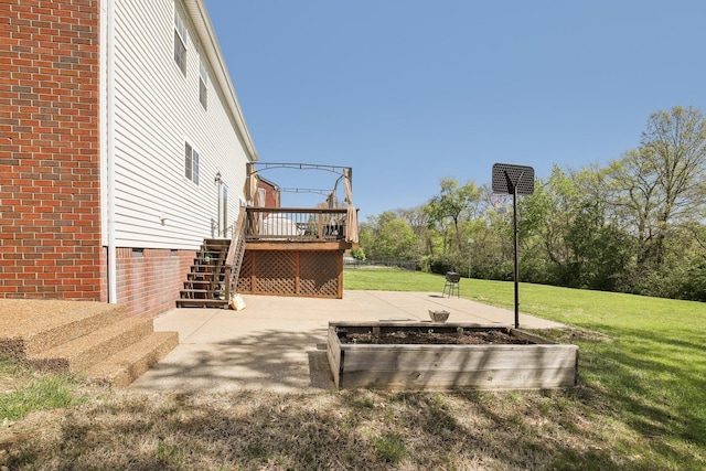 view of yard with stairs and a deck