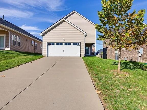 3728 Hoggett Ford Rd, Hermitage, TN 37076 - view of front of home with a garage, driveway, and a front lawn