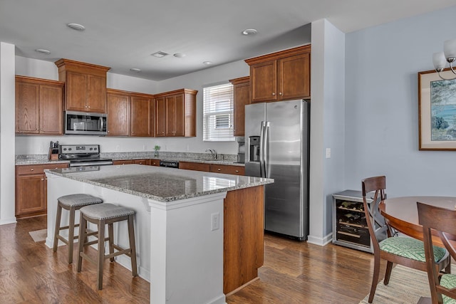 3728 Hoggett Ford Rd, Hermitage, TN 37076 - kitchen with a sink, light stone countertops, a center island, appliances with stainless steel finishes, and dark wood-style flooring