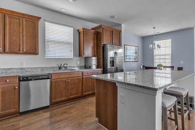 3728 Hoggett Ford Rd, Hermitage, TN 37076 - kitchen featuring a center island, a sink, dark wood-style flooring, a breakfast bar, and appliances with stainless steel finishes