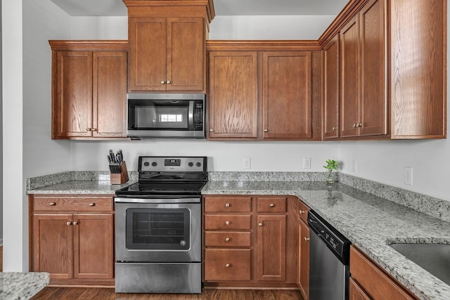 3728 Hoggett Ford Rd, Hermitage, TN 37076 - kitchen with brown cabinets, dark wood finished floors, light stone countertops, and appliances with stainless steel finishes