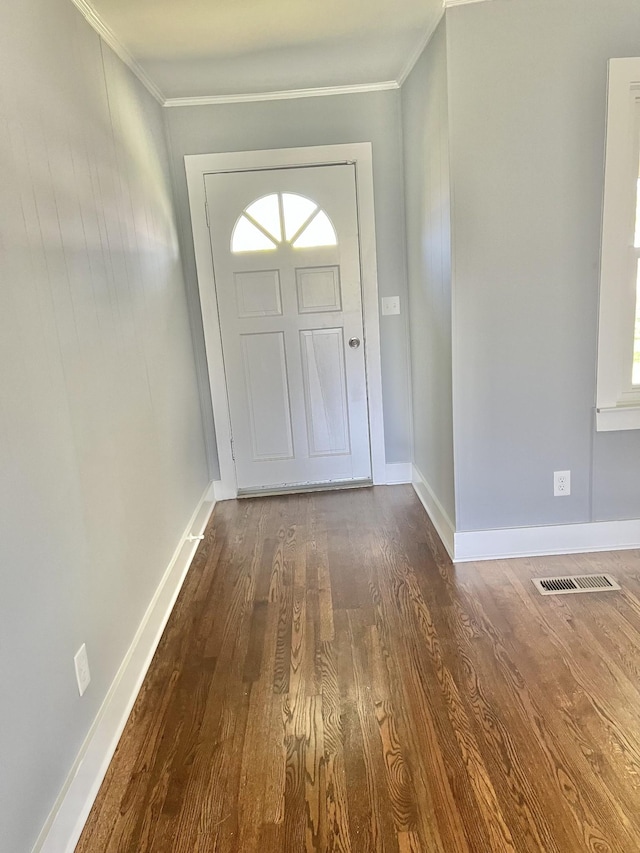 foyer entrance featuring dark wood finished floors, baseboards, a healthy amount of sunlight, and crown molding