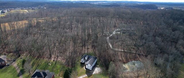 drone / aerial view with a wooded view