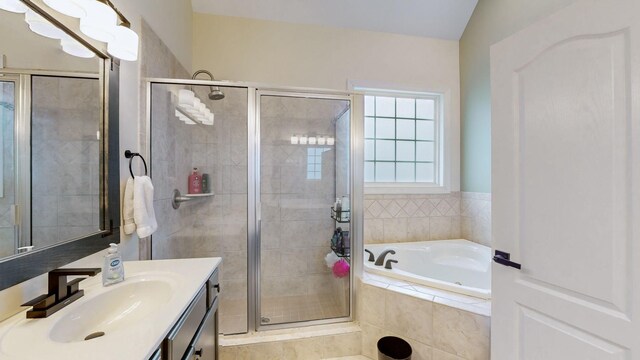 bathroom featuring a bath, vanity, and a stall shower