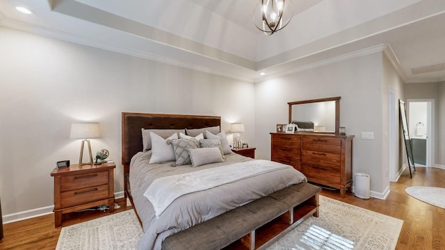 bedroom featuring baseboards, wood finished floors, recessed lighting, and crown molding