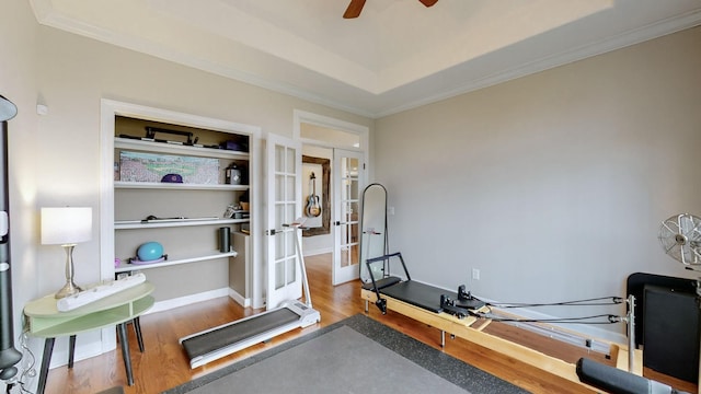 exercise room with ceiling fan, ornamental molding, french doors, and wood finished floors